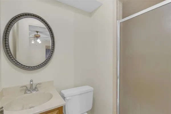 an empty room with windows and fan