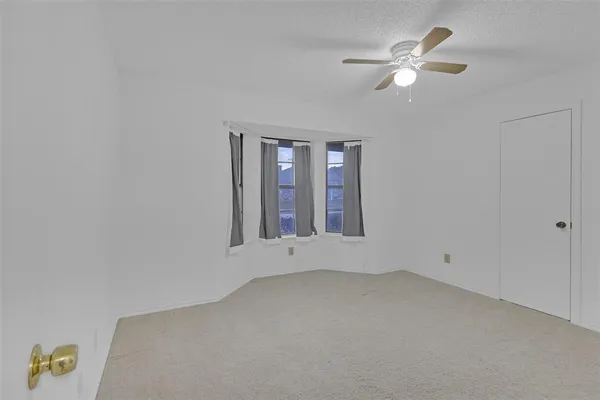 a bathroom with a granite countertop sink a toilet a mirror and shower