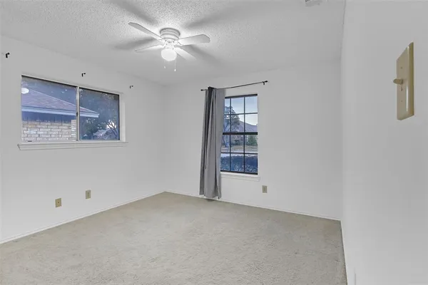 a view of an empty room with a fan