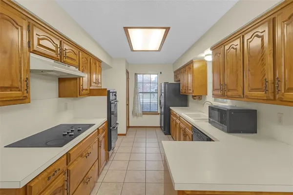 a kitchen with a sink refrigerator and cabinets
