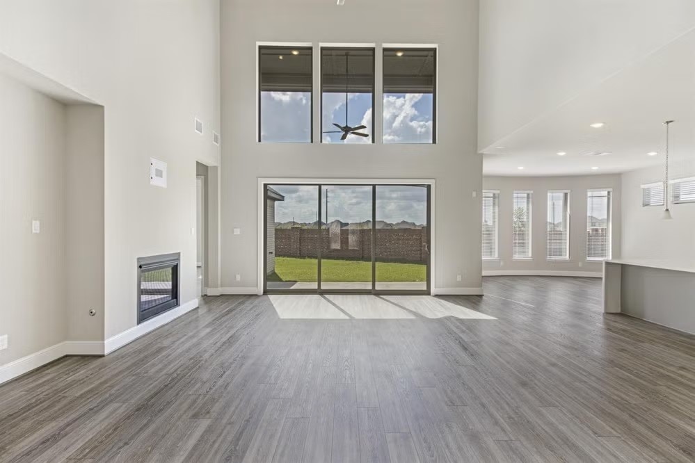 6418 Seville Street Manvel, TX 77578 - Photo 3 of 7 a view of an empty room with wooden floor and a fireplace