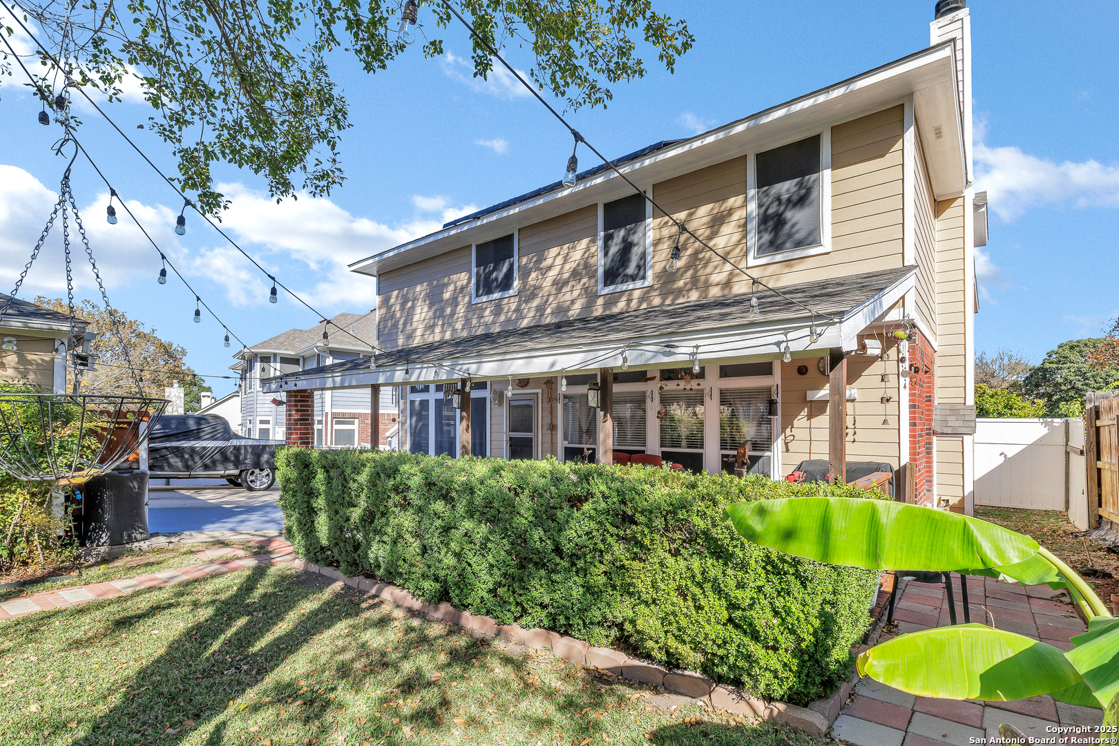 1611 Springhouse Street San Antonio, TX 78251 - Photo 28 of 30 a view of a house with a yard and table and chairs under an umbrella