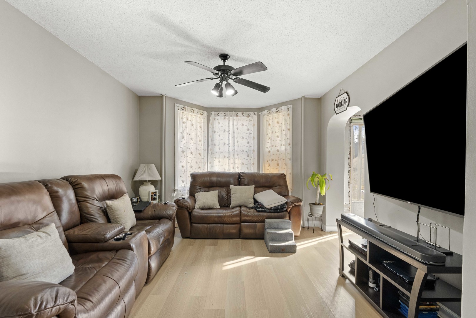 2922 East 97th Street Chicago, IL 60617 - Photo 12 of 20 a living room with furniture a flat screen tv and a window