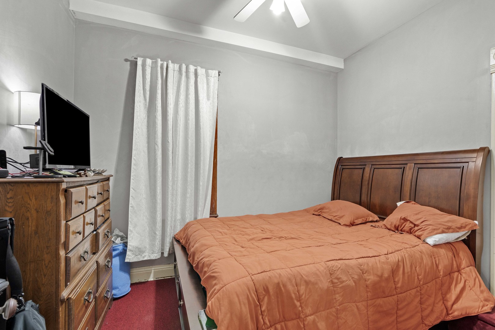 2922 East 97th Street Chicago, IL 60617 - Photo 14 of 20 a bedroom with a bed flat screen tv and a window