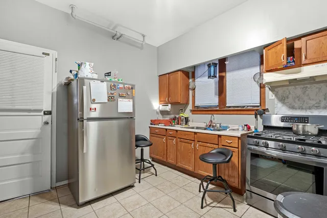 a kitchen with stainless steel appliances a refrigerator stove and sink