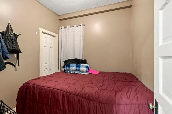 a bedroom with a bed and a mirror