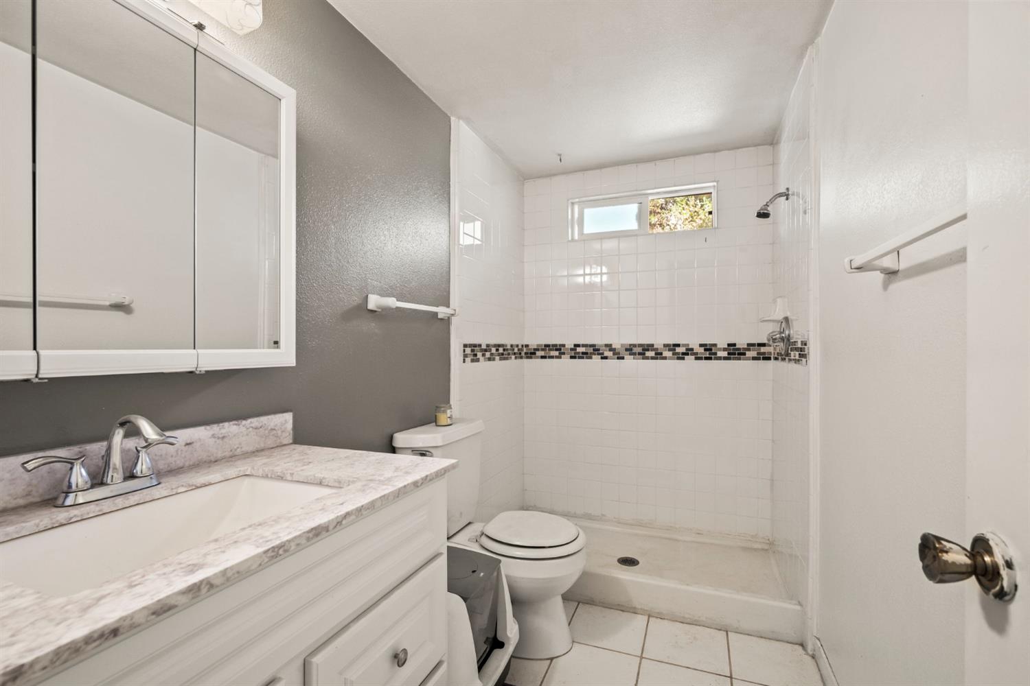 2860 Jim Valley Road Placerville, CA 95667 - Photo 16 of 34 a bathroom with a granite countertop sink a mirror and a toilet