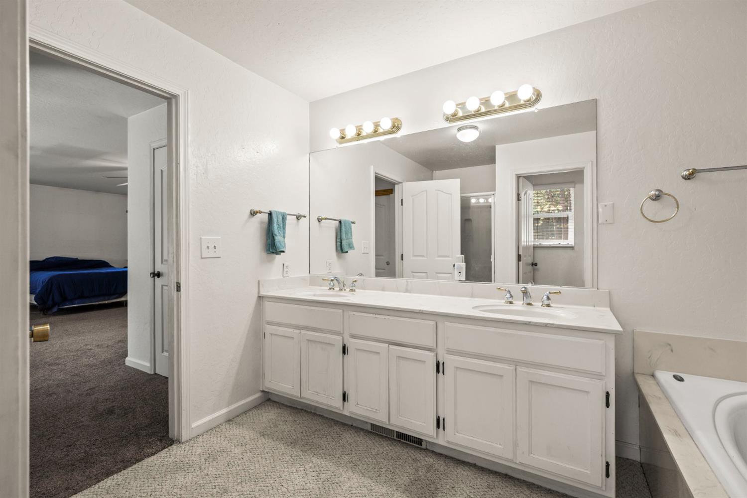 2860 Jim Valley Road Placerville, CA 95667 - Photo 20 of 34 a en suite bathroom with a double vanity sink and a mirror