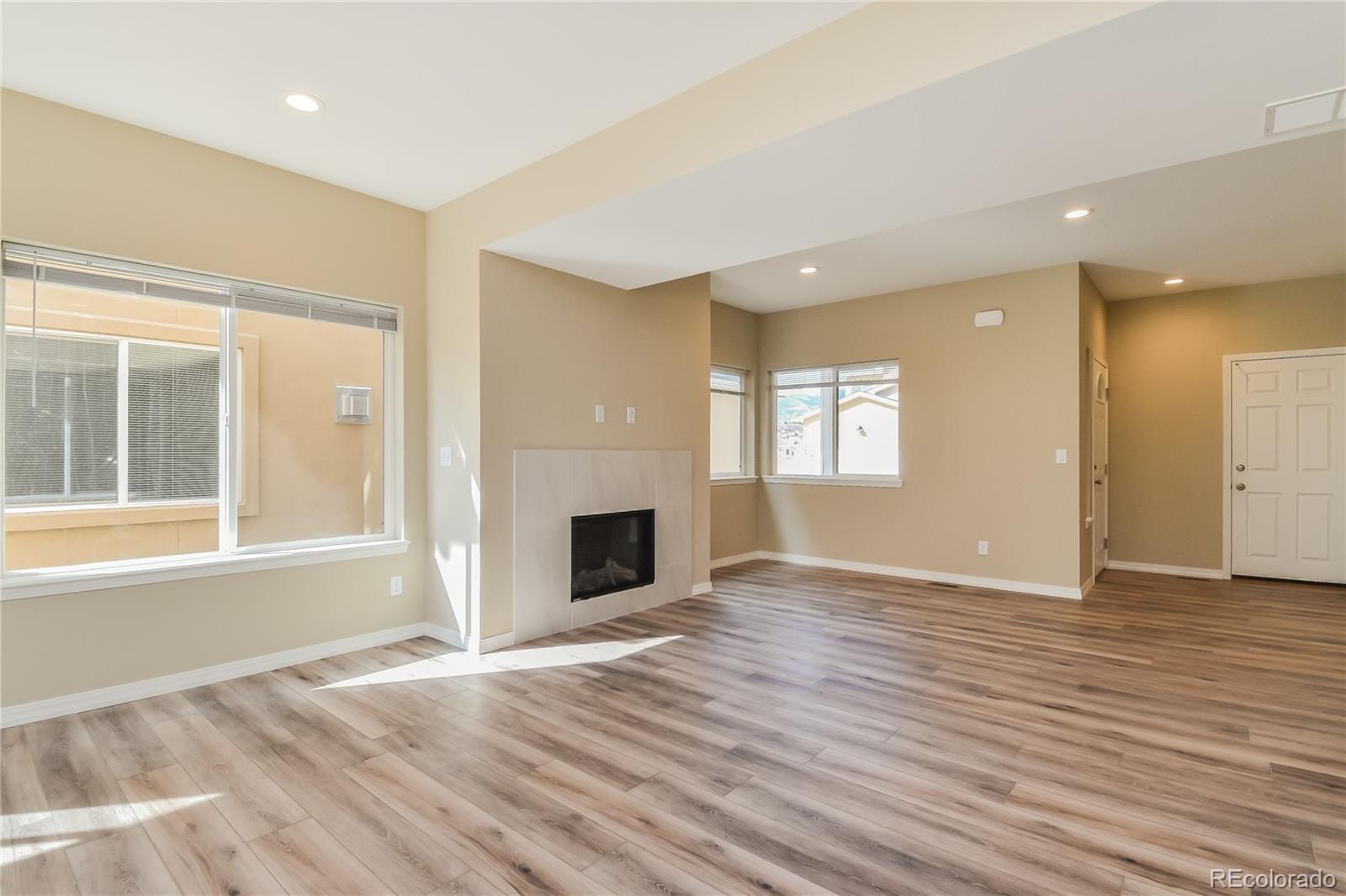 4441 Light View Colorado Springs, CO 80907 - Photo 3 of 17 a view of an empty room with window and wooden floor