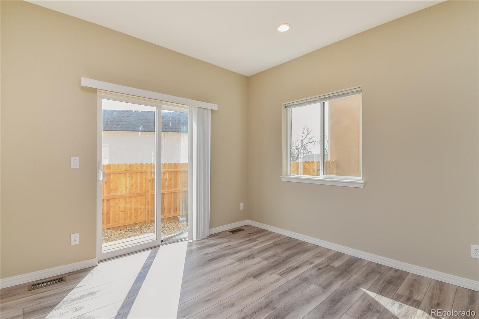 4441 Light View Colorado Springs, CO 80907 - Photo 4 of 17 an empty room with wooden floor and windows