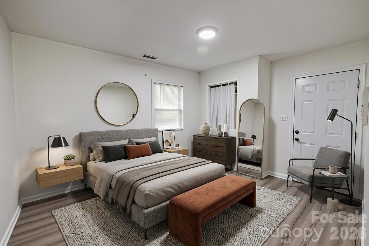 2545 Cedarwild Road Charlotte, NC 28212 - Photo 21 of 25 a bedroom with bed and a potted plant