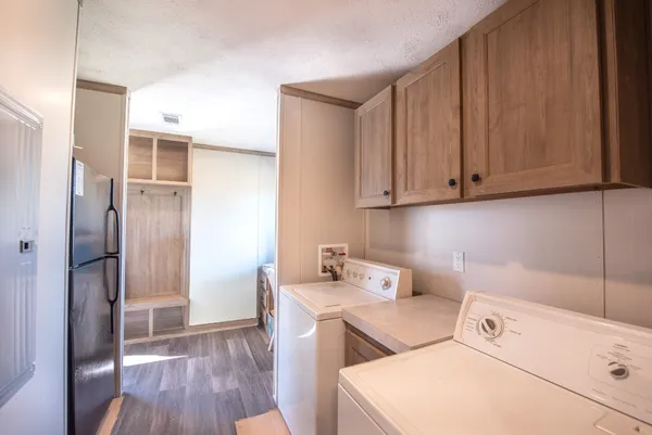 a utility room with dryer washer and a refrigerator