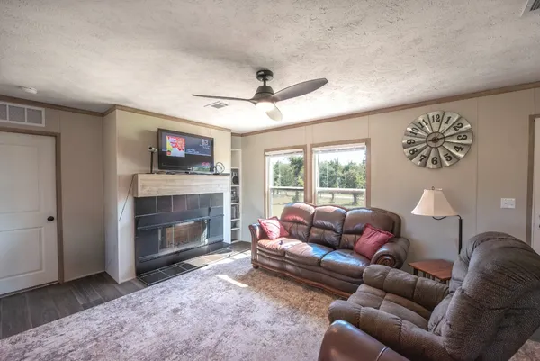 a living room with furniture and a fireplace