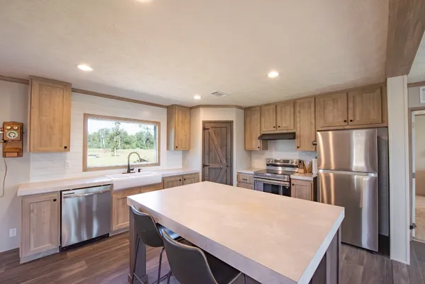 a kitchen with refrigerator cabinets dining table and chairs