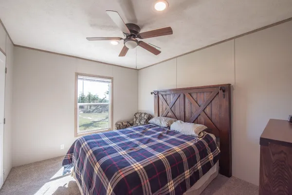 a bedroom with a bed and window
