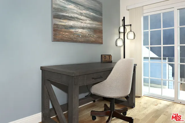 a view of a workspace with furniture and a window