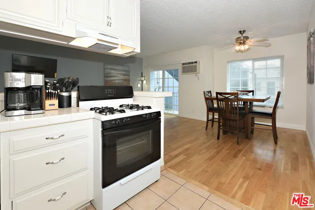 a kitchen with a table chairs and a stove