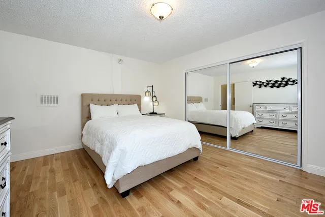 a bedroom with two beds and a walk in closet