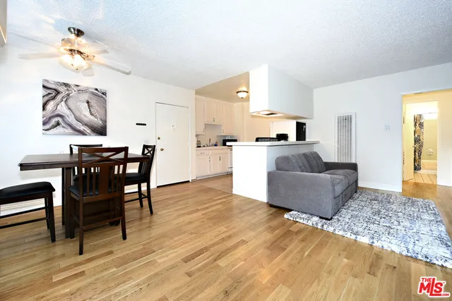 a living room with furniture and kitchen view