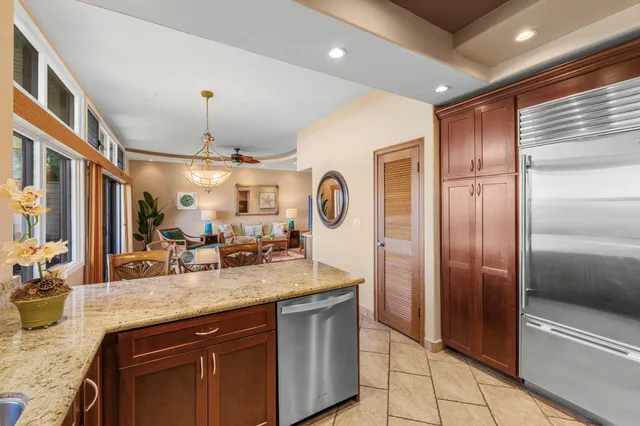 a kitchen with granite countertop stainless steel appliances and wooden cabinets