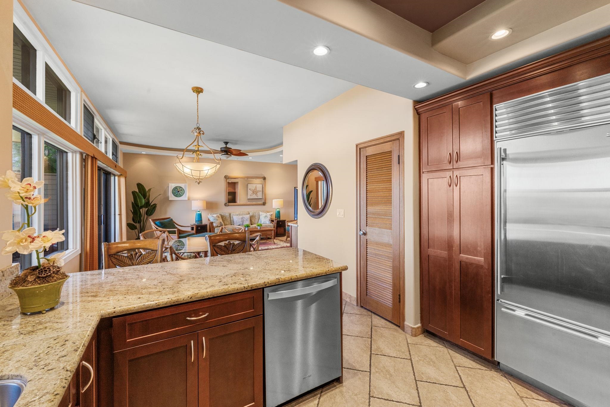 100 Ridge Road, Unit 1614 Lahaina, HI 96761 - Photo 10 of 50 a kitchen with granite countertop stainless steel appliances and wooden cabinets
