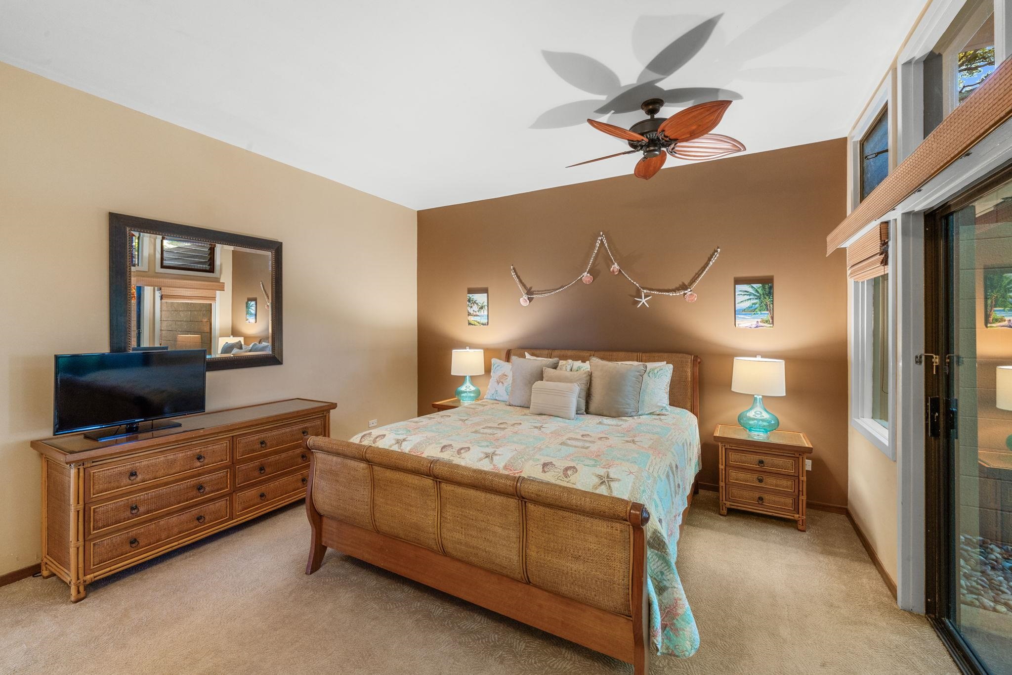 100 Ridge Road, Unit 1614 Lahaina, HI 96761 - Photo 14 of 50 a bedroom with a bed and a flat tv screen on dresser