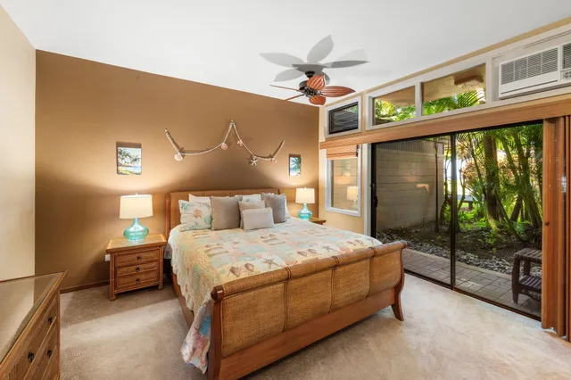 a bedroom with a bed and a ceiling fan