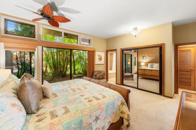 a bedroom with a bed and large window with outer view