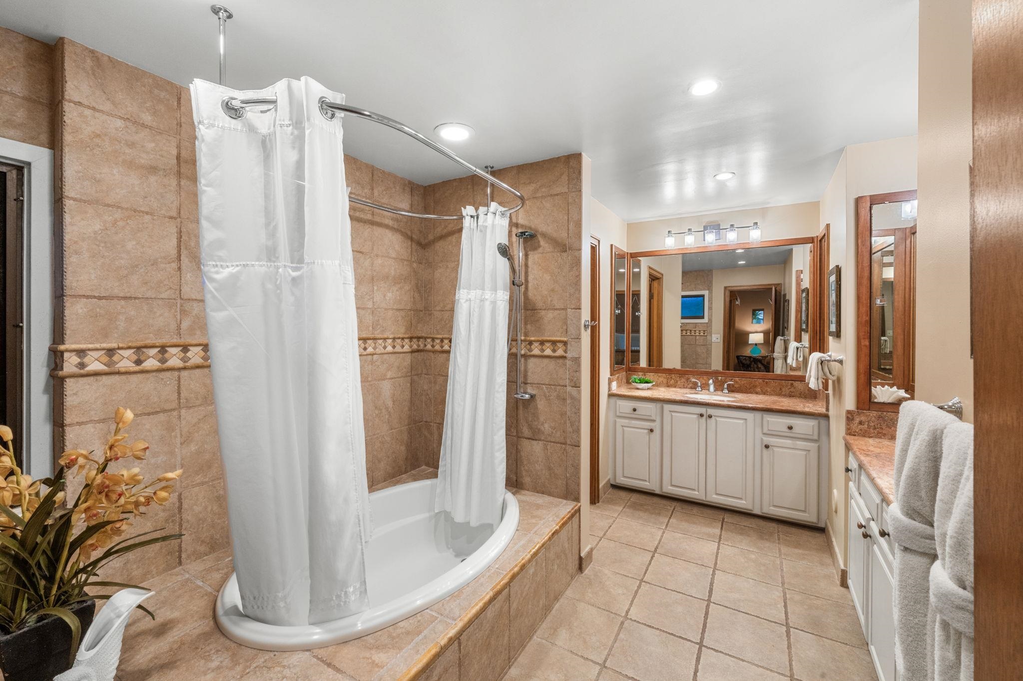 100 Ridge Road, Unit 1614 Lahaina, HI 96761 - Photo 18 of 50 a bathroom with a double vanity sink a mirror a bathtub and shower
