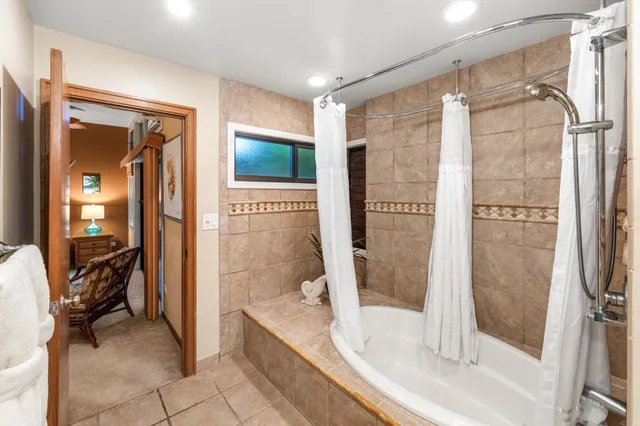 a bathroom with a bathtub and a shower