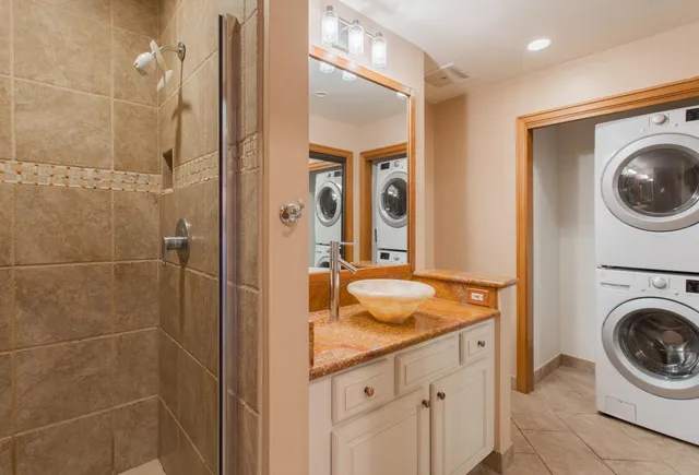 a bathroom with a sink a washer and dryer