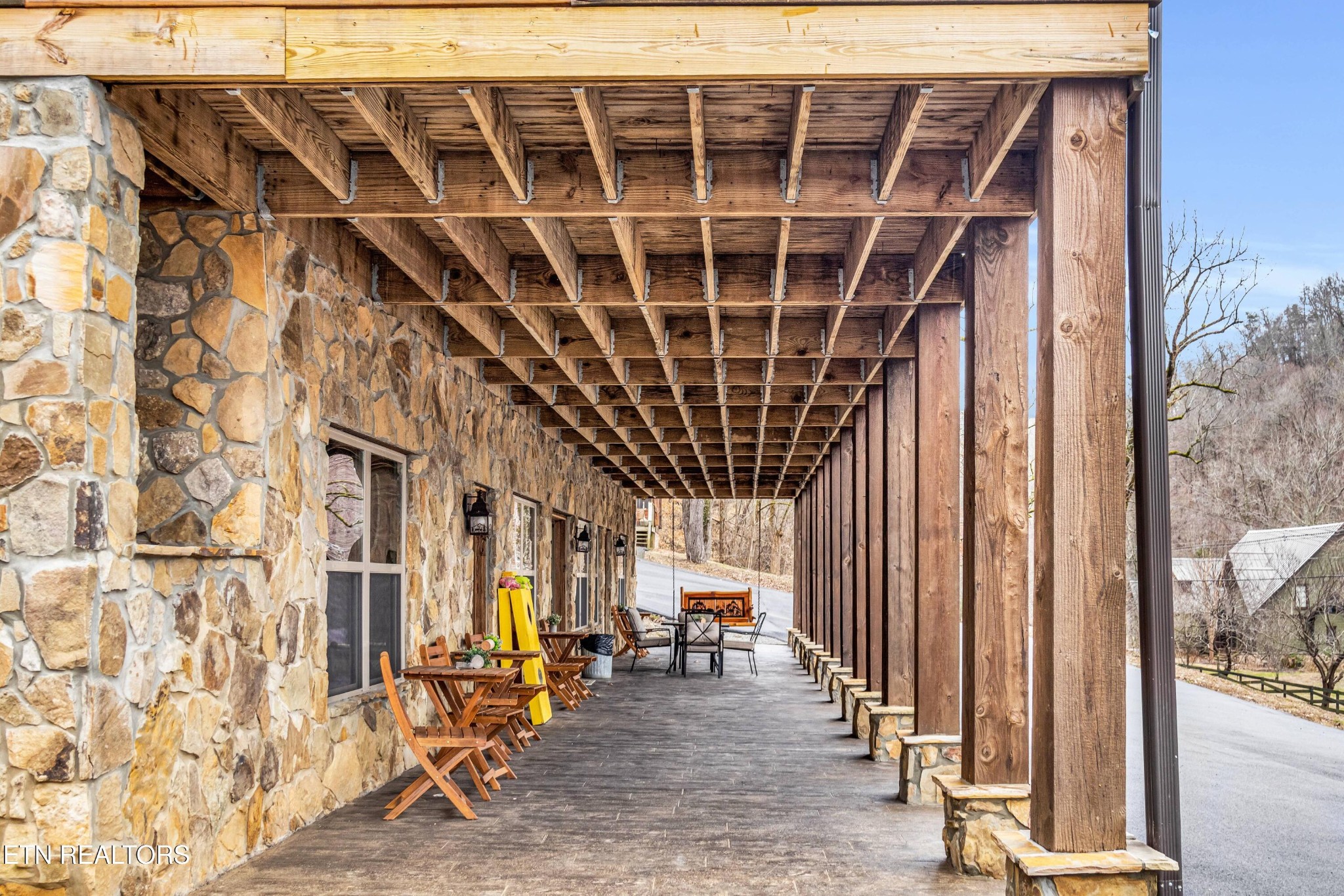 173 Rafter Road Tellico Plains, TN 37385 - Photo 13 of 49 a view of an empty room with wooden floor and windows