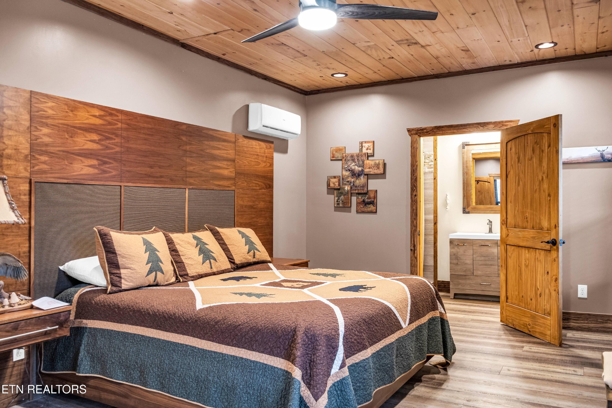 173 Rafter Road Tellico Plains, TN 37385 - Photo 30 of 49 a bedroom with a bed and wooden floor