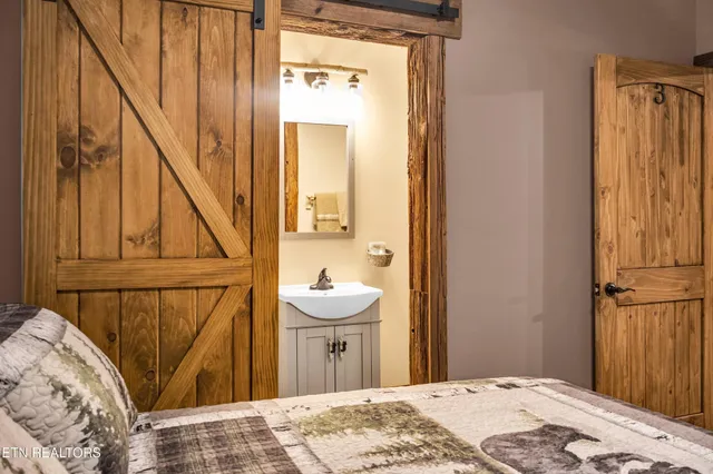 a bedroom with furniture and a flat screen tv