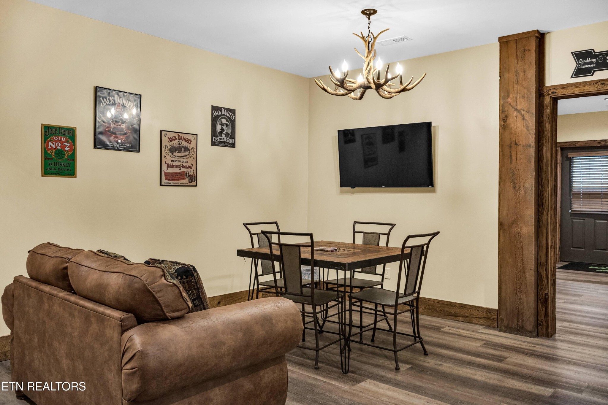 173 Rafter Road Tellico Plains, TN 37385 - Photo 37 of 49 a living room with furniture a flat screen tv and a chandelier