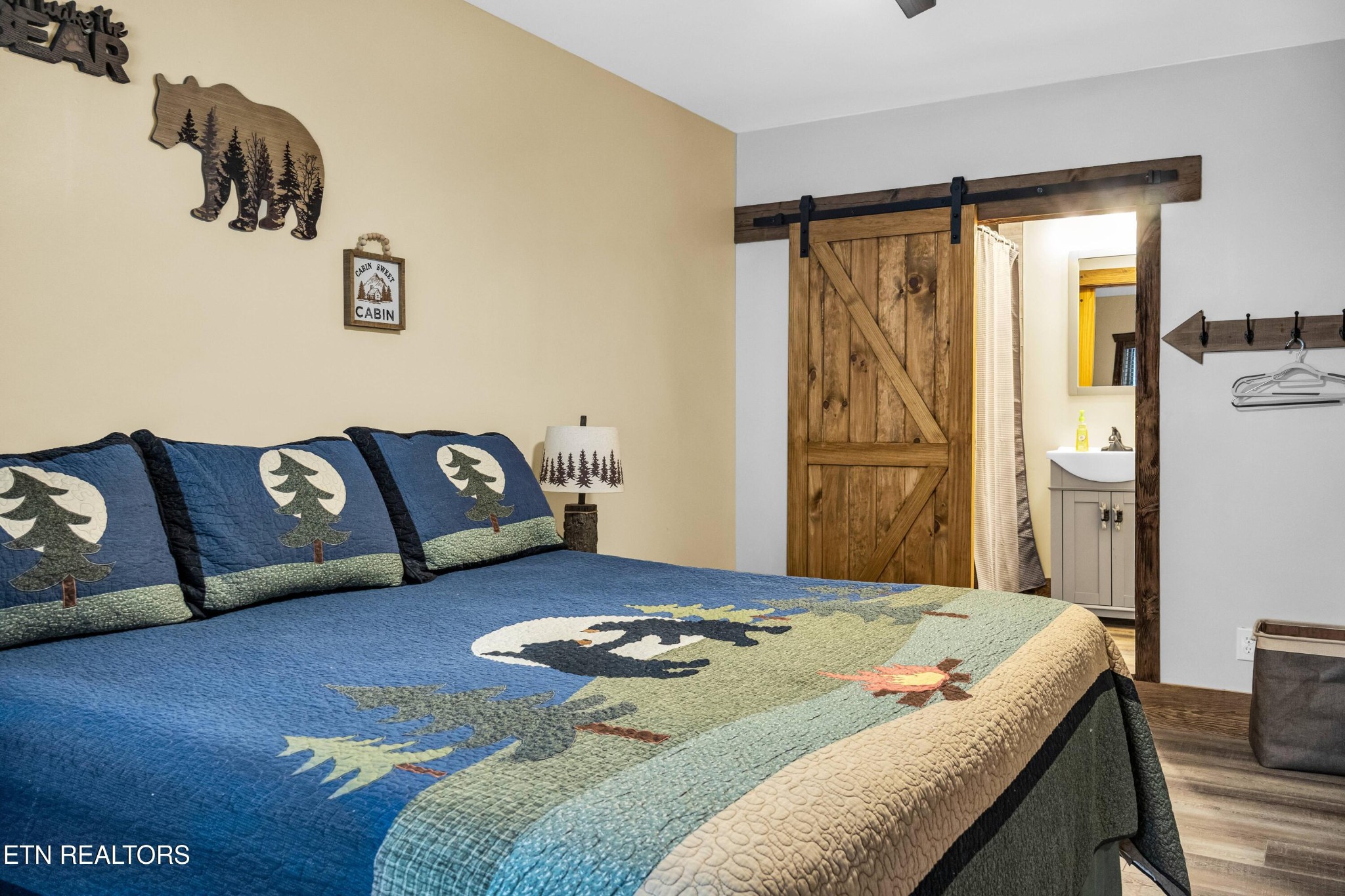 173 Rafter Road Tellico Plains, TN 37385 - Photo 38 of 49 a bedroom with a bed and a couch