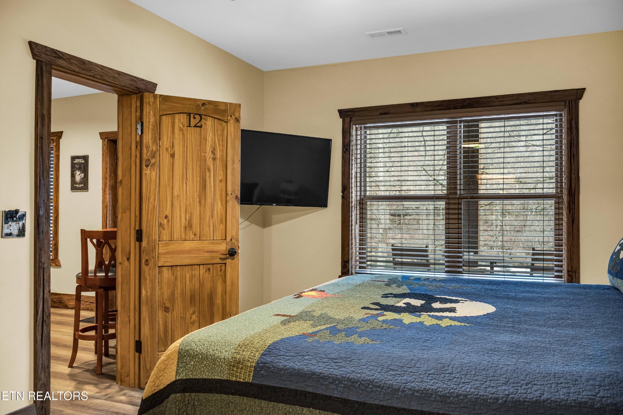 173 Rafter Road Tellico Plains, TN 37385 - Photo 39 of 49 a bedroom with a bed and a flat screen tv