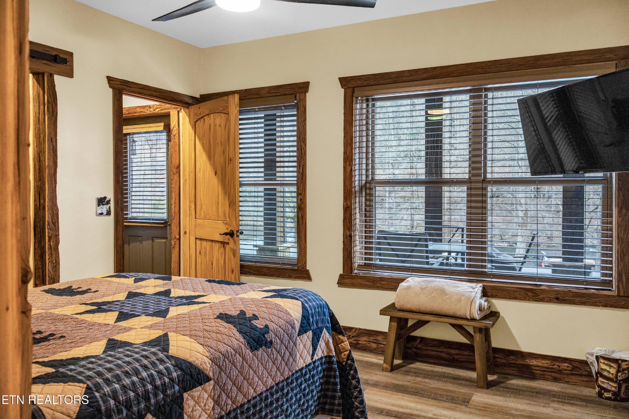 173 Rafter Road Tellico Plains, TN 37385 - Photo 41 of 49 a bedroom with a bed and large windows