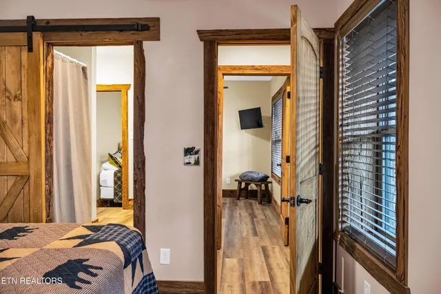 a bedroom with a bed and flat screen tv