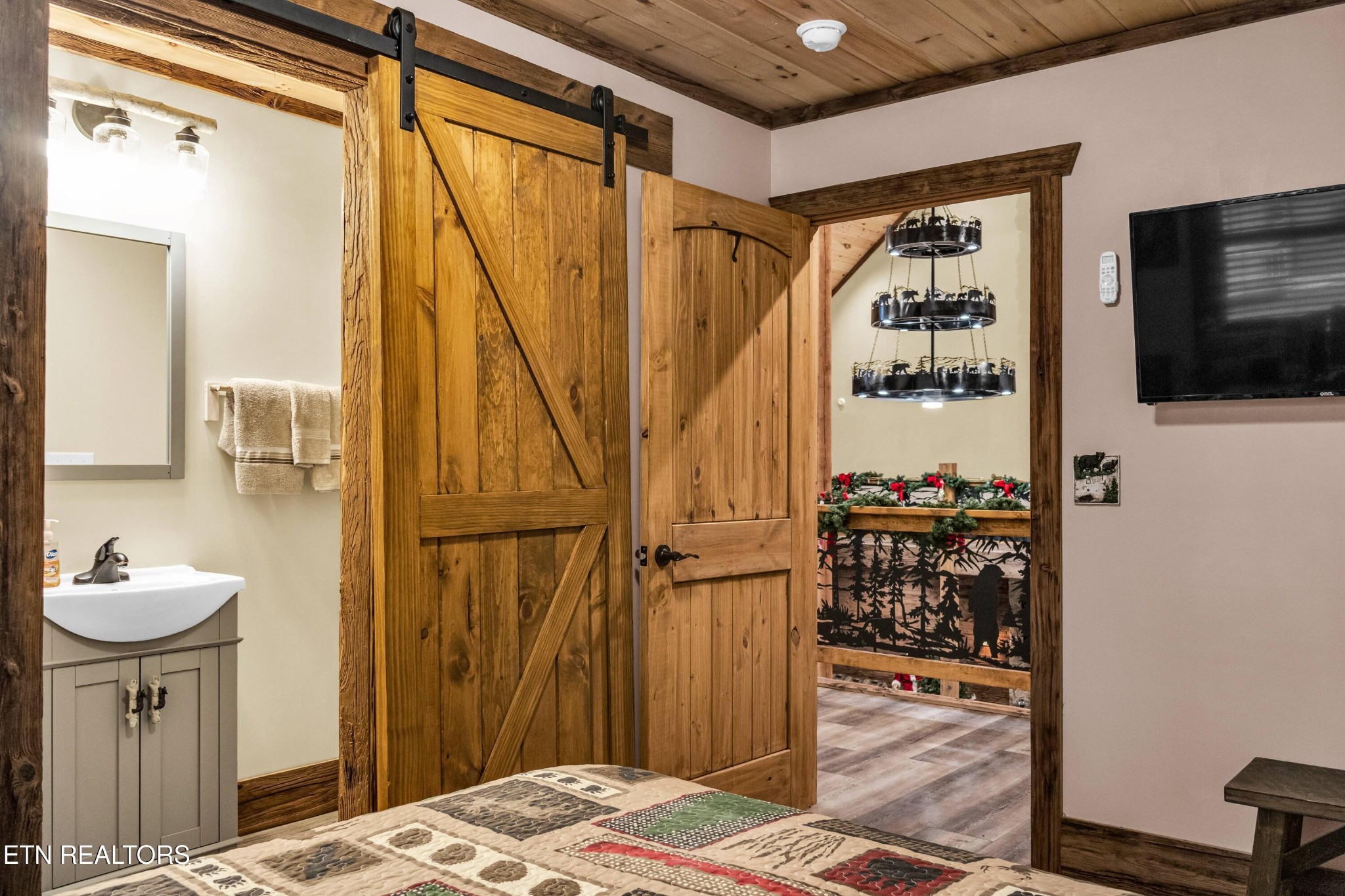 173 Rafter Road Tellico Plains, TN 37385 - Photo 48 of 49 a bedroom with a bed and a television