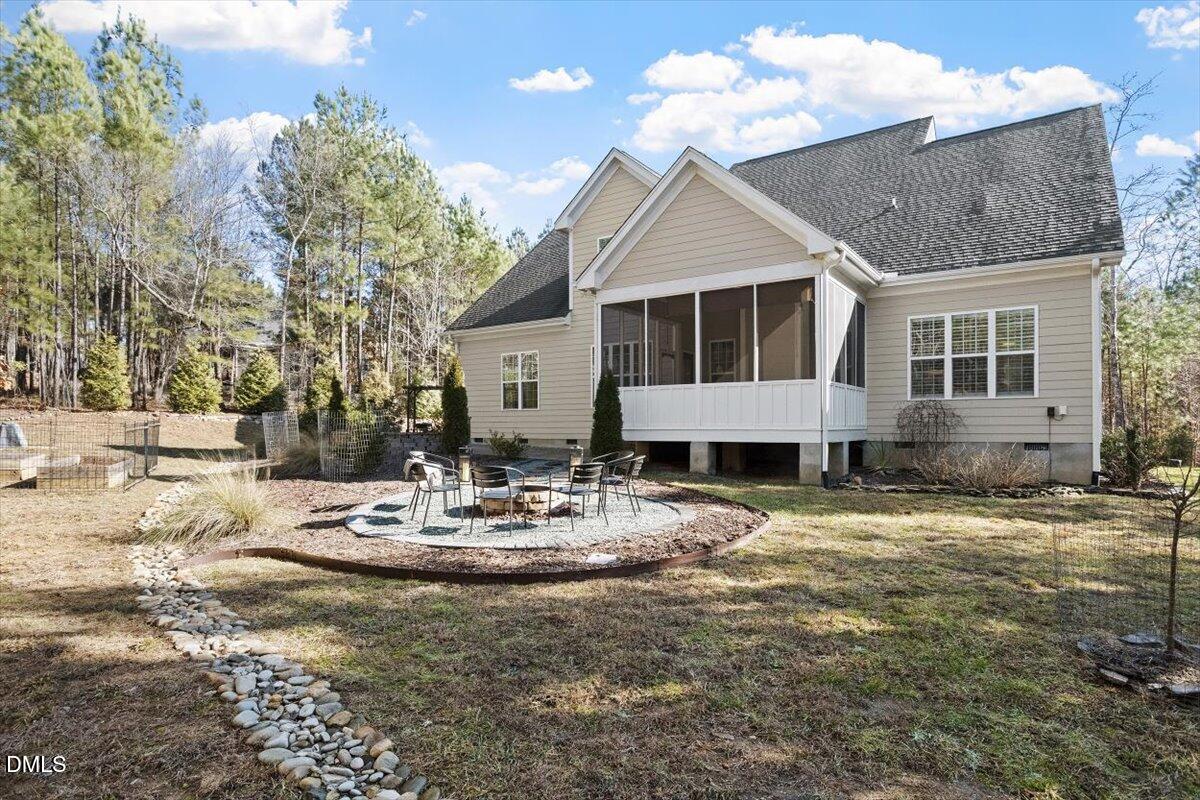 1321 Cedar Grove Road Pittsboro, NC 27312 - Photo 10 of 82 a view of a white house with a yard and sitting area