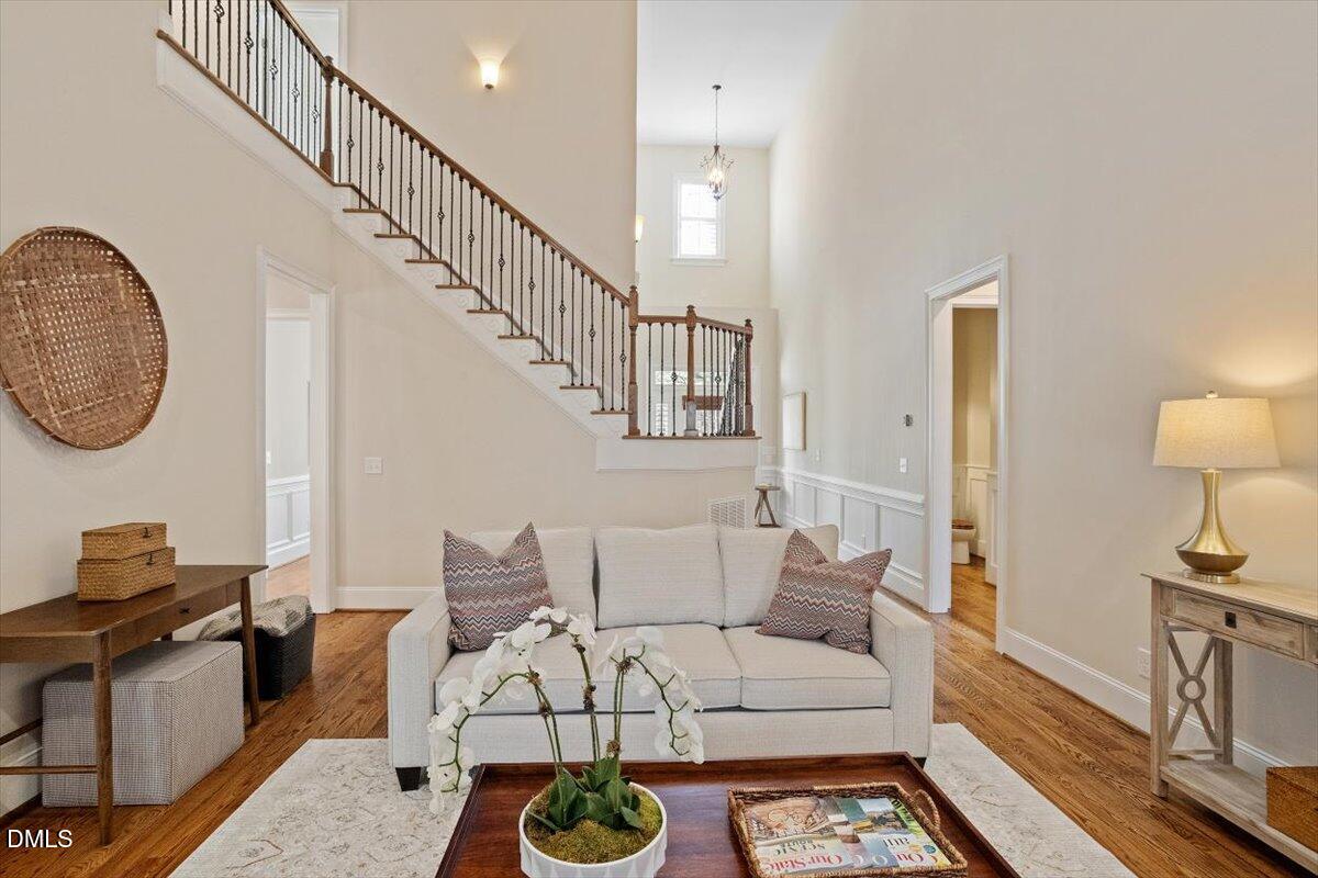 1321 Cedar Grove Road Pittsboro, NC 27312 - Photo 29 of 82 a living room with furniture a mirror and a wooden floor