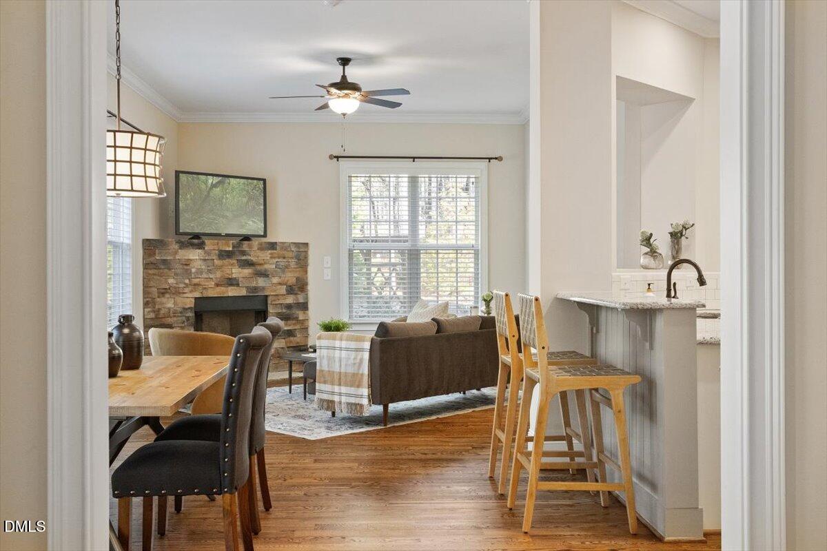 1321 Cedar Grove Road Pittsboro, NC 27312 - Photo 49 of 82 a dining room with furniture a chandelier and wooden floor