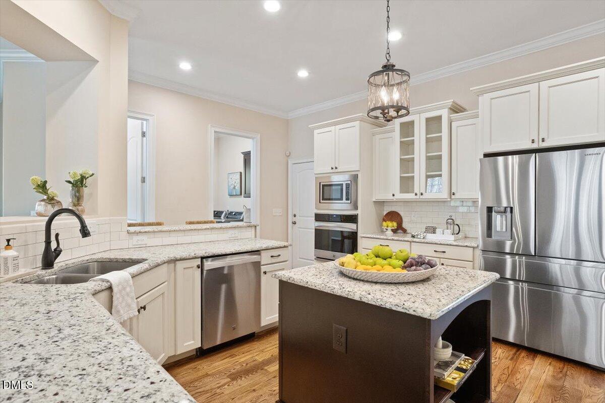 1321 Cedar Grove Road Pittsboro, NC 27312 - Photo 55 of 82 a kitchen with granite countertop a sink stainless steel appliances and cabinets
