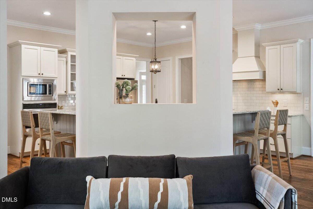 1321 Cedar Grove Road Pittsboro, NC 27312 - Photo 65 of 82 a living room with furniture a chandelier and kitchen view