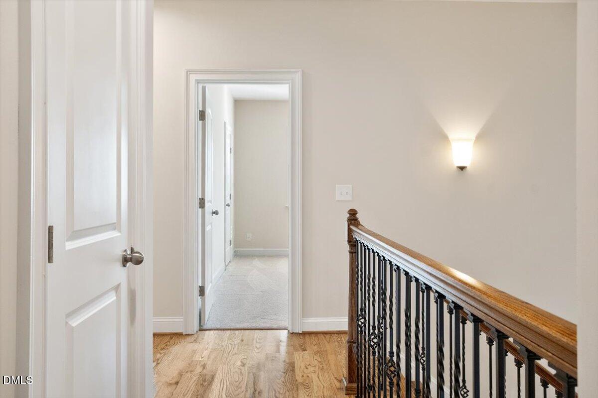 1321 Cedar Grove Road Pittsboro, NC 27312 - Photo 68 of 82 a view of a hallway with wooden floor and staircase
