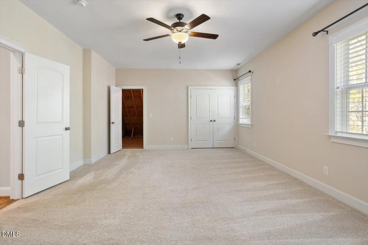 1321 Cedar Grove Road Pittsboro, NC 27312 - Photo 77 of 82 an empty room with windows and a ceiling fan