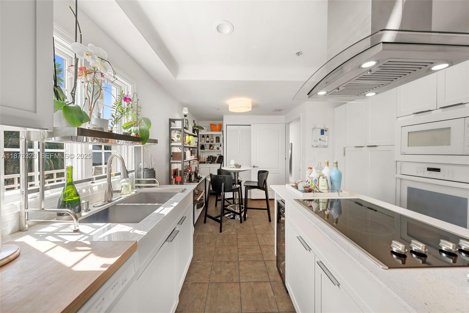 1415 Sunset Harbour Drive, Unit 406 Miami Beach, FL 33139 - Photo 11 of 83 a large white kitchen with lots of counter top space