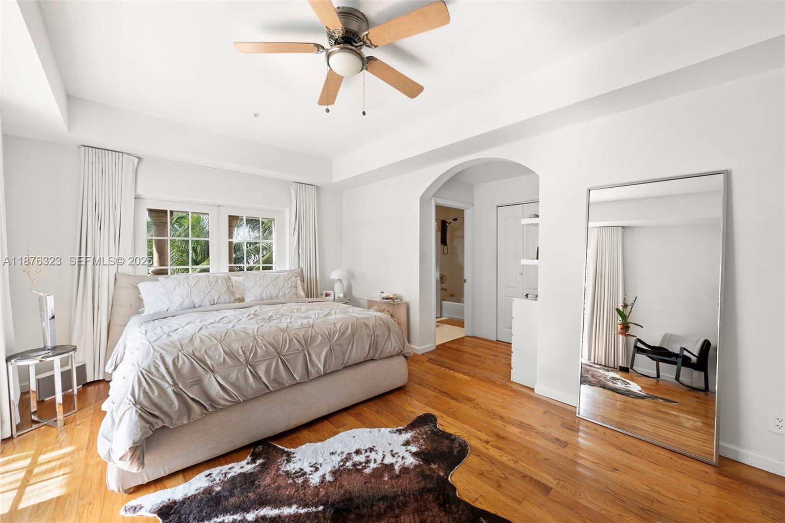 1415 Sunset Harbour Drive, Unit 406 Miami Beach, FL 33139 - Photo 28 of 83 a spacious bedroom with a bed and a chandelier