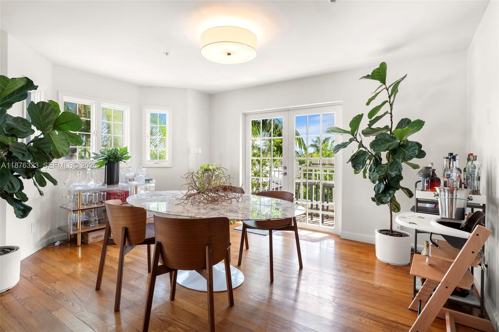 1415 Sunset Harbour Drive, Unit 406 Miami Beach, FL 33139 - Photo 6 of 83 a view of a dining room with furniture window and wooden floor